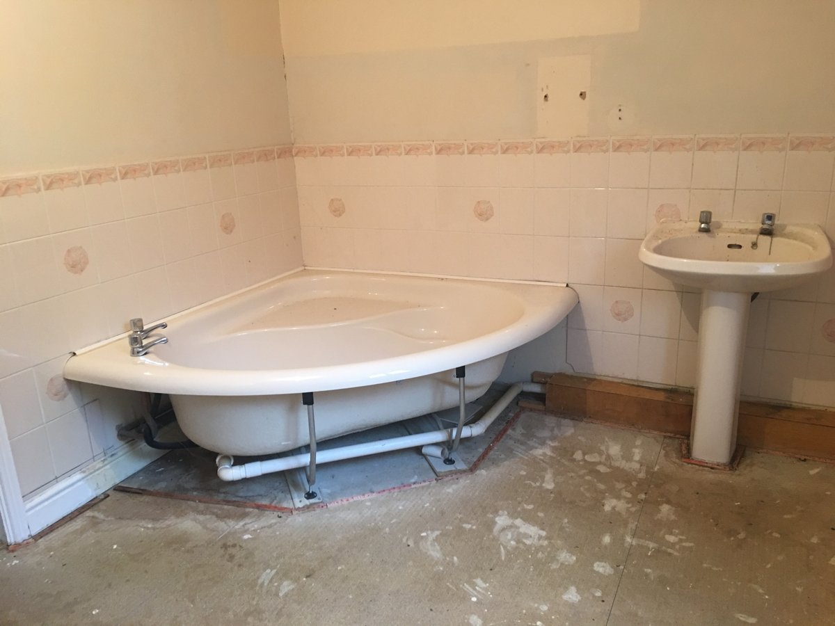 image shows: bathroom refurbishment corner bath joys green 