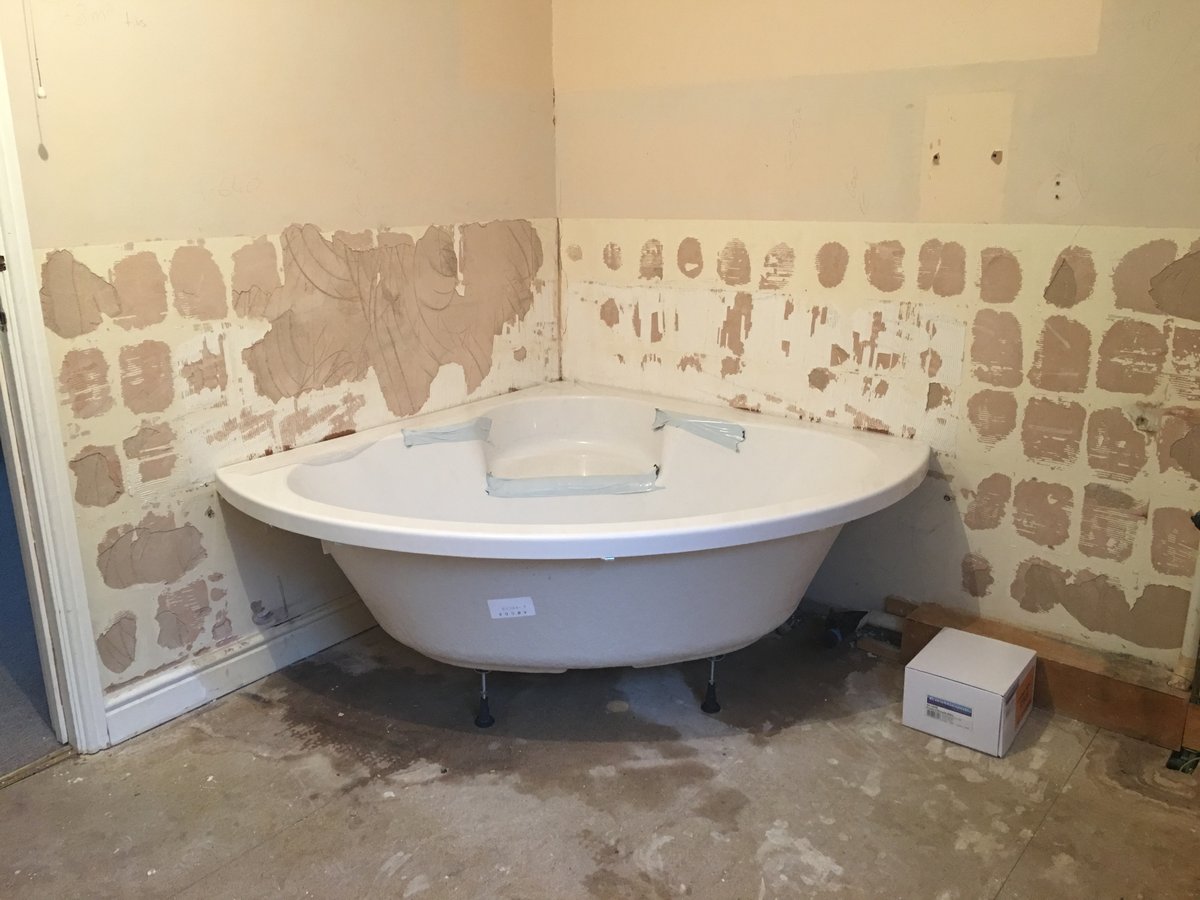 image shows: bathroom refurbishment corner bath joys green 