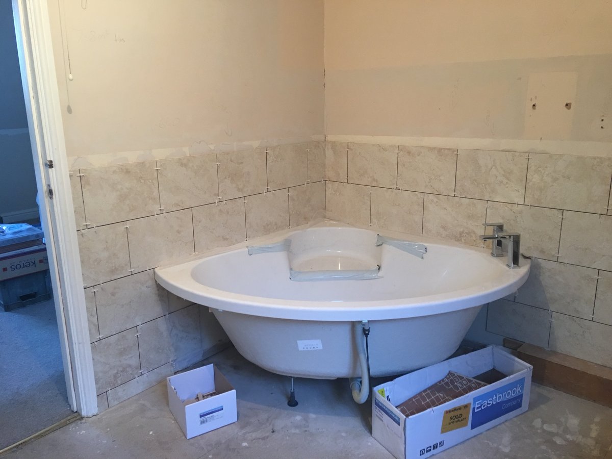 image shows: bathroom refurbishment corner bath joys green 