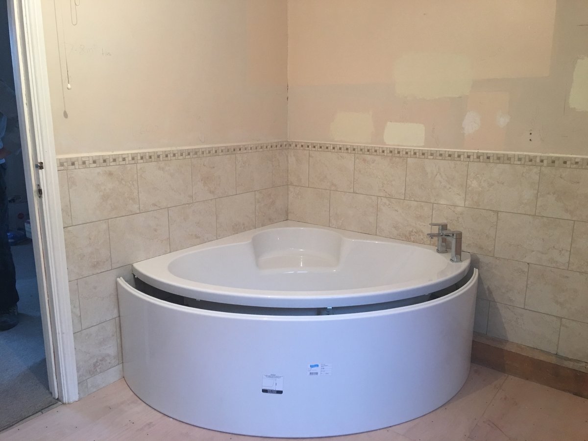 image shows: bathroom refurbishment corner bath joys green 