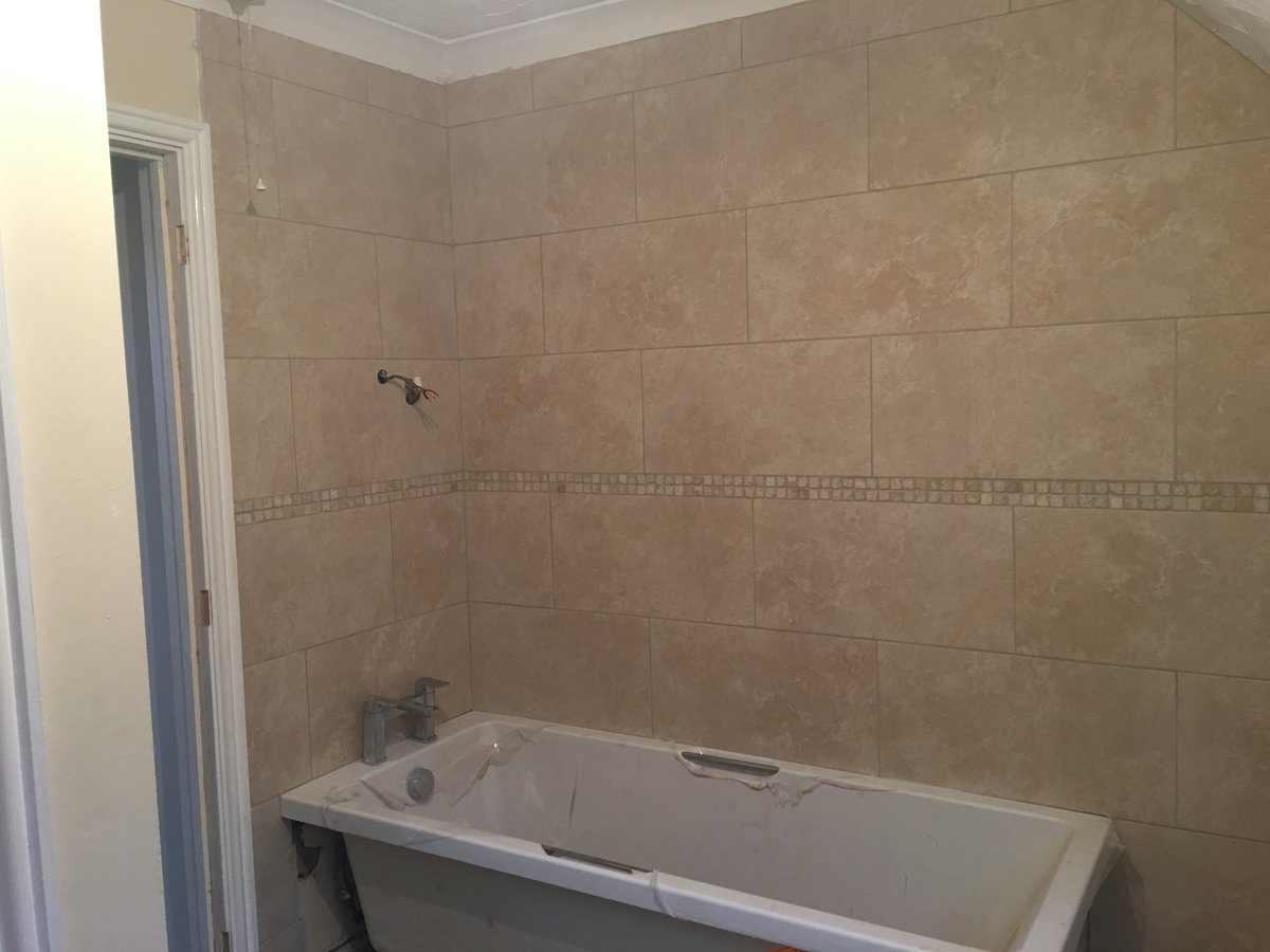 image shows: bathroom refurbishment corner bath joys green 