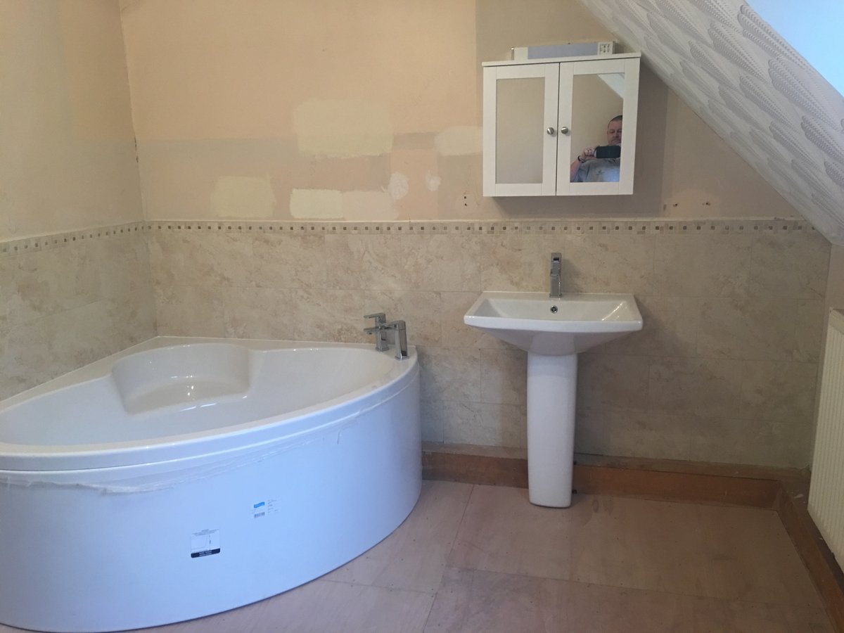 image shows: bathroom refurbishment corner bath joys green 